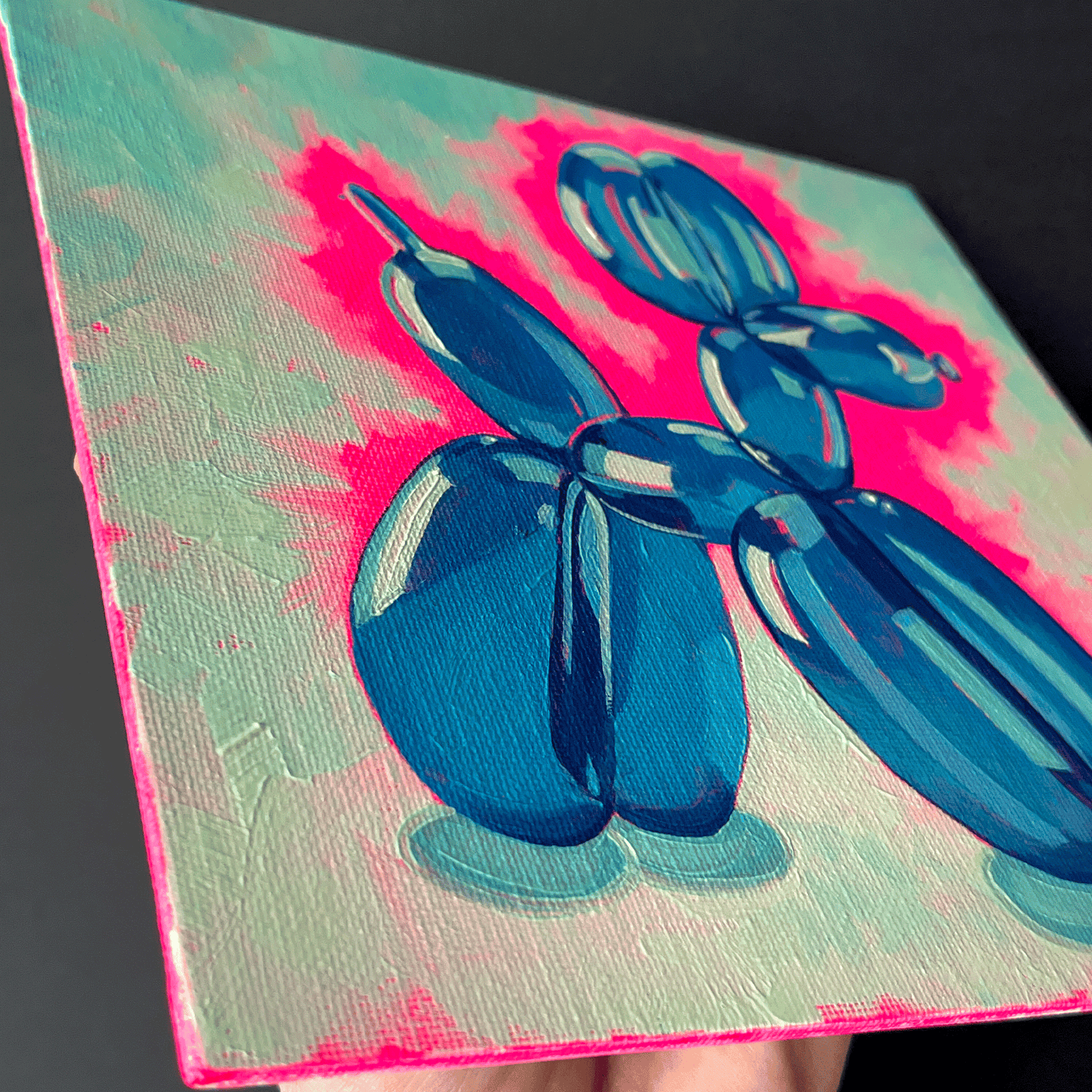 Blue balloon dog sculpture on a colorful background