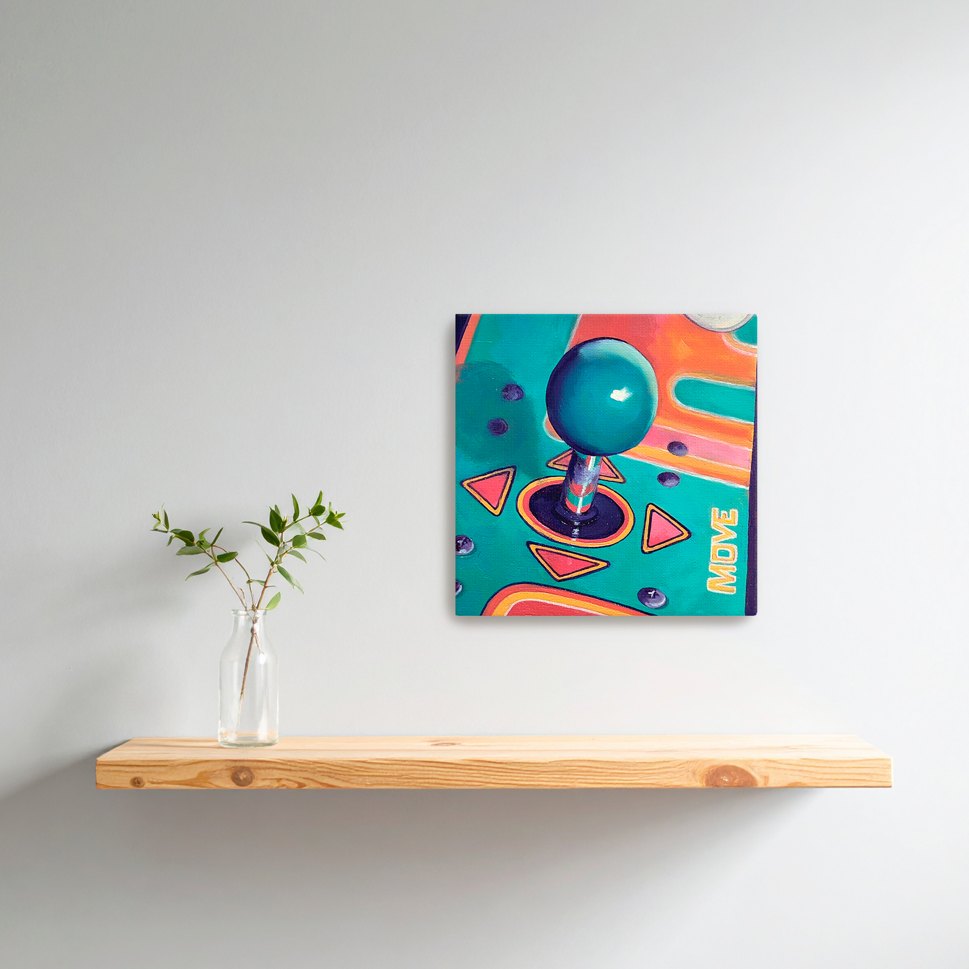 Colorful arcade joystick painting on a white wall above a wooden shelf with a vase.