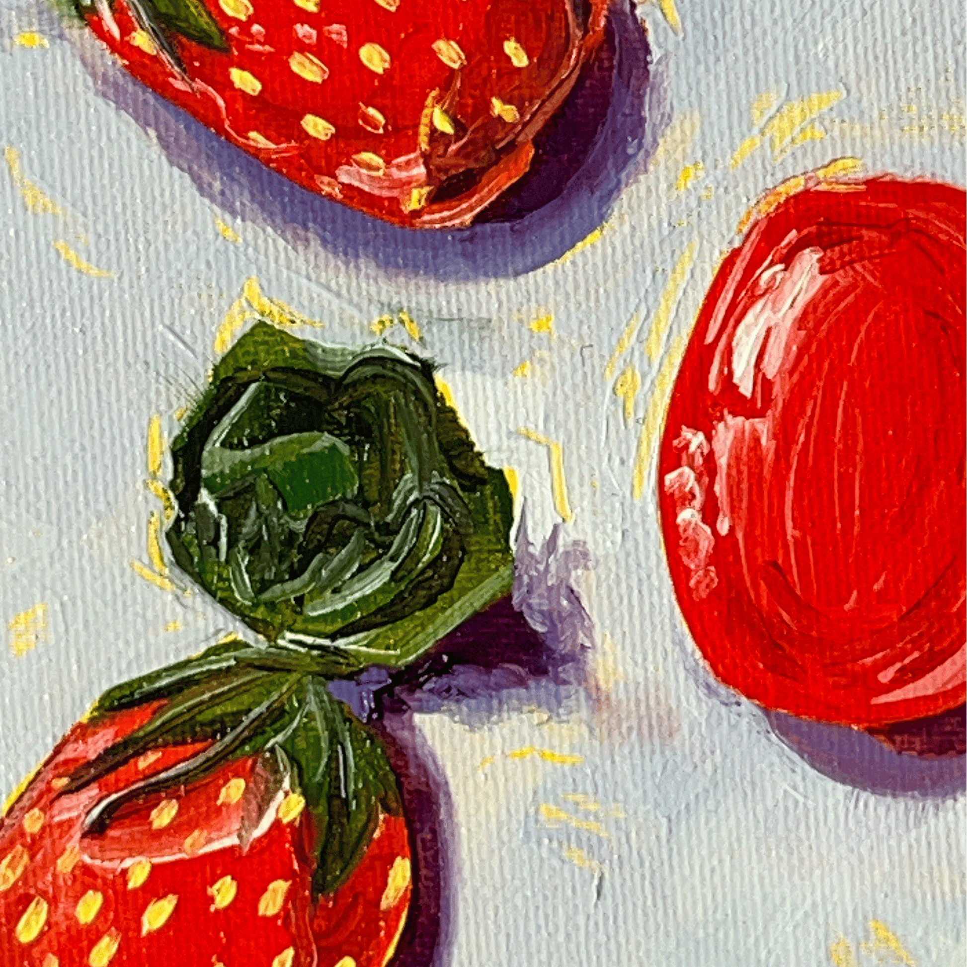 Close-up of painted strawberry candies with shiny wrappers on a textured surface.