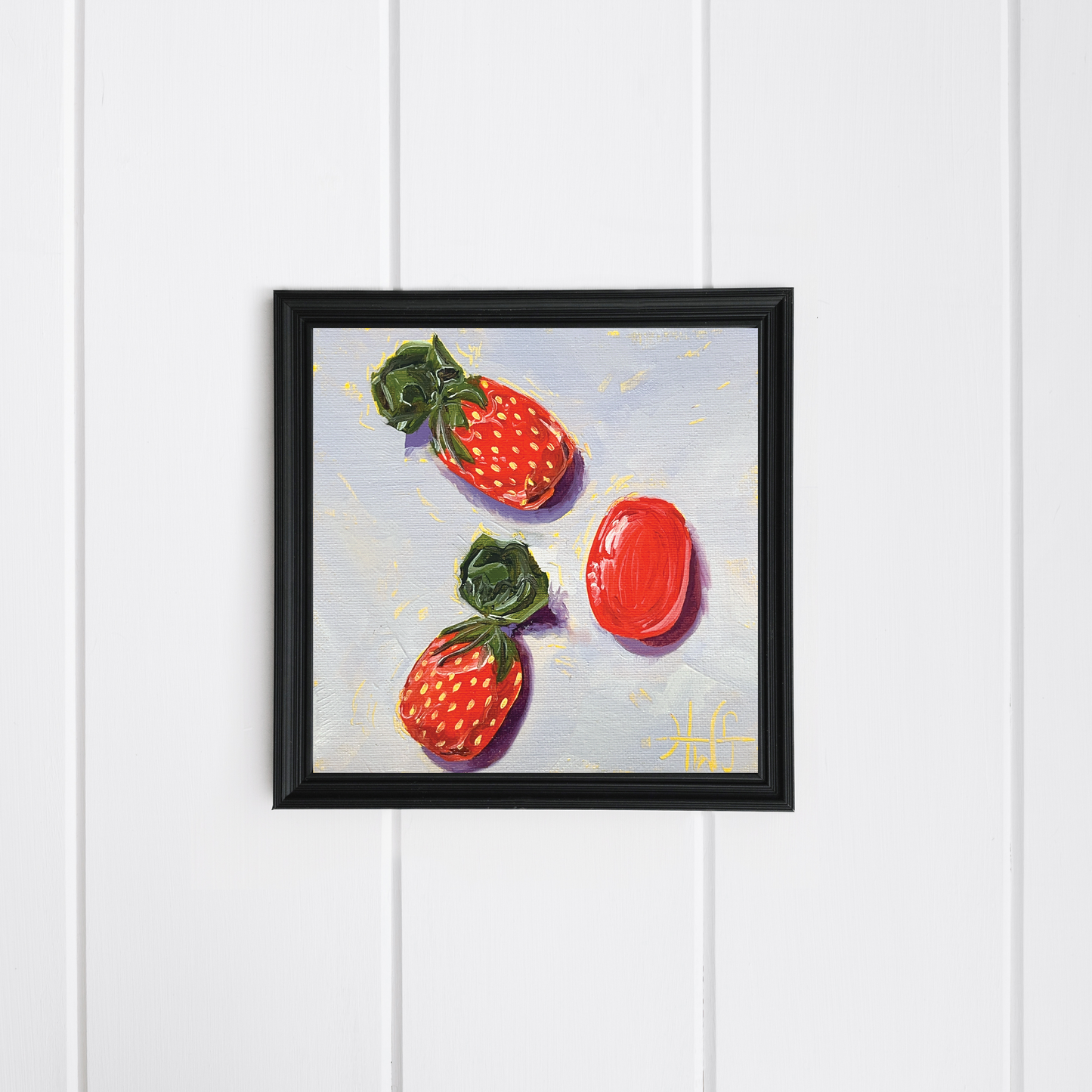 Framed artwork of strawberry candy on a white wooden panel background
